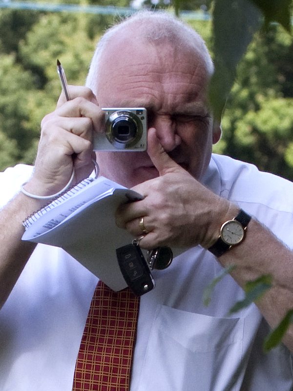 Close view of the officer with camera and notepad